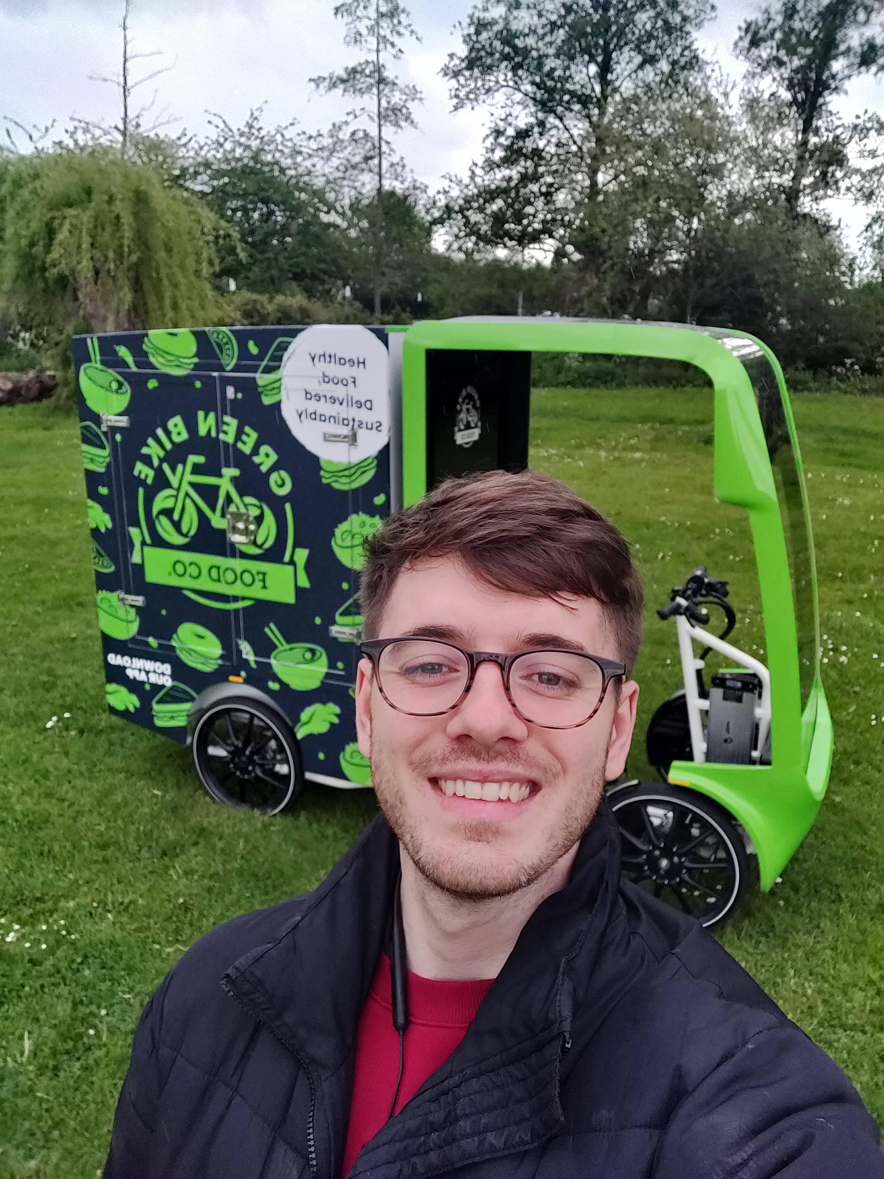 Jack Boitier with a Green Bike Food delivery bike
